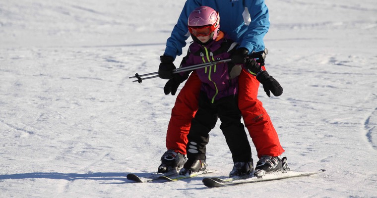 Barn som håller på att lära sig åka skidor