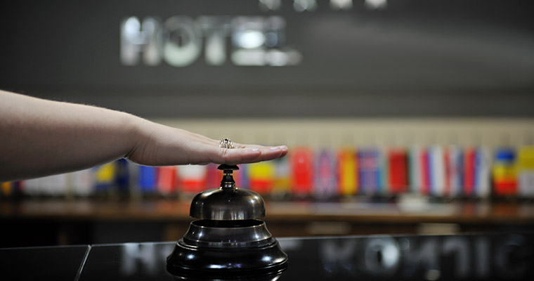 En receptionist trycker på klockan.