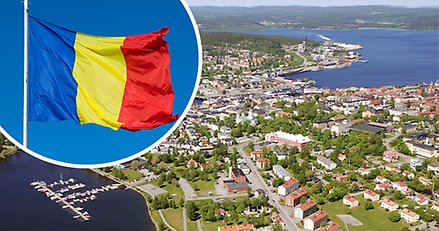 flygbild över centrala Härnösand, landområde och vatten, en rumänsk flagga infälld i bilden