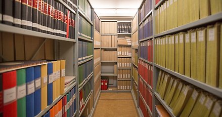 Hyllor med pärmar och mappar i ett arkiv.
