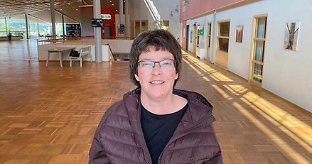 Porträttbild av en leende kvinna som är fotograferad inomhus.