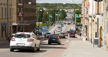 Gata med mycket trafik på och en bro i bakgrunden.