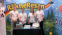 Fyra gymnasister framför en monter med texten "Räkneresan".